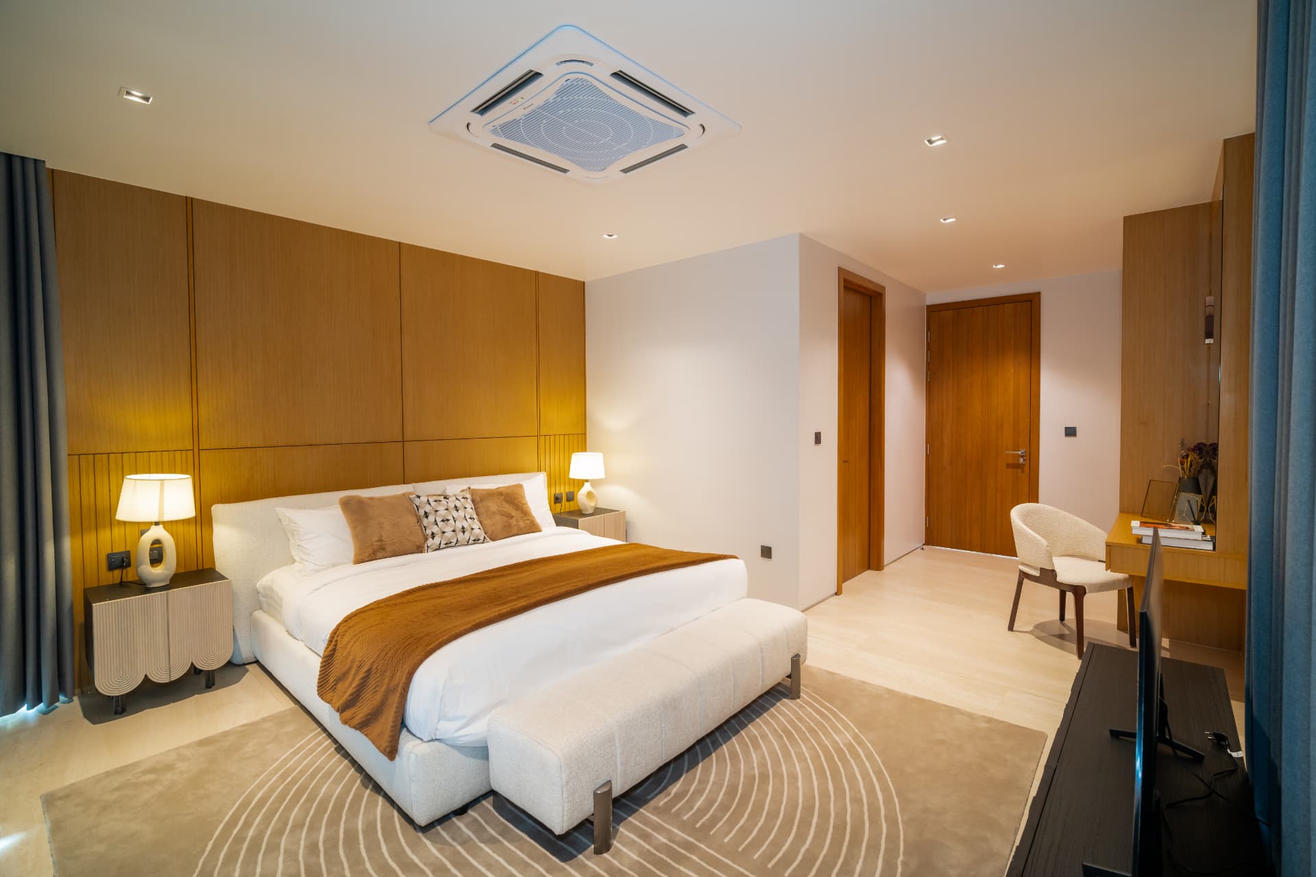 Botanica Foresta II — bedroom with a timber panelled headboard wall and dressed bedside lamps