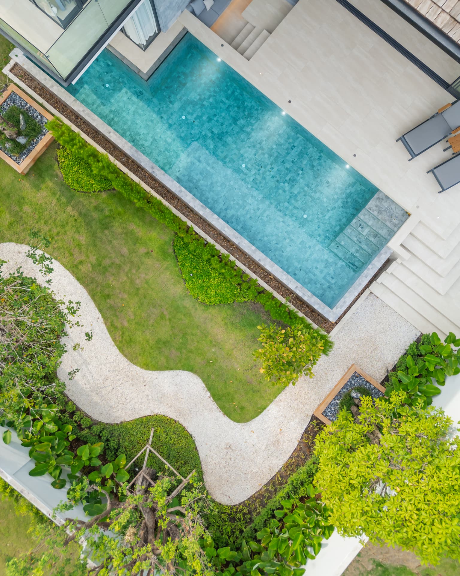 Botanica Foresta II — aerial view of the pool and curving garden path