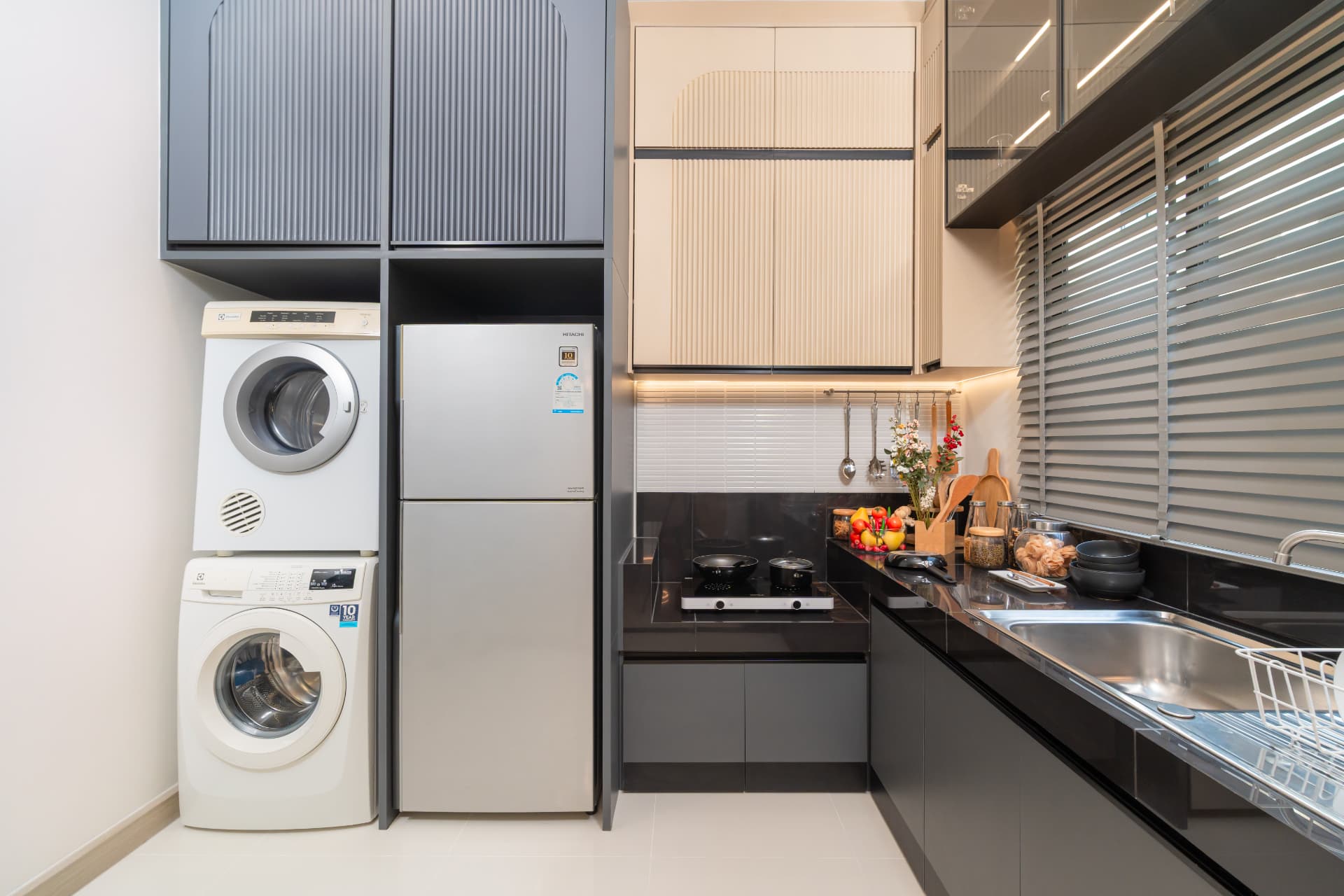 K Avenue II — kitchen with stacked washer and dryer, refrigerator and countertop appliances
