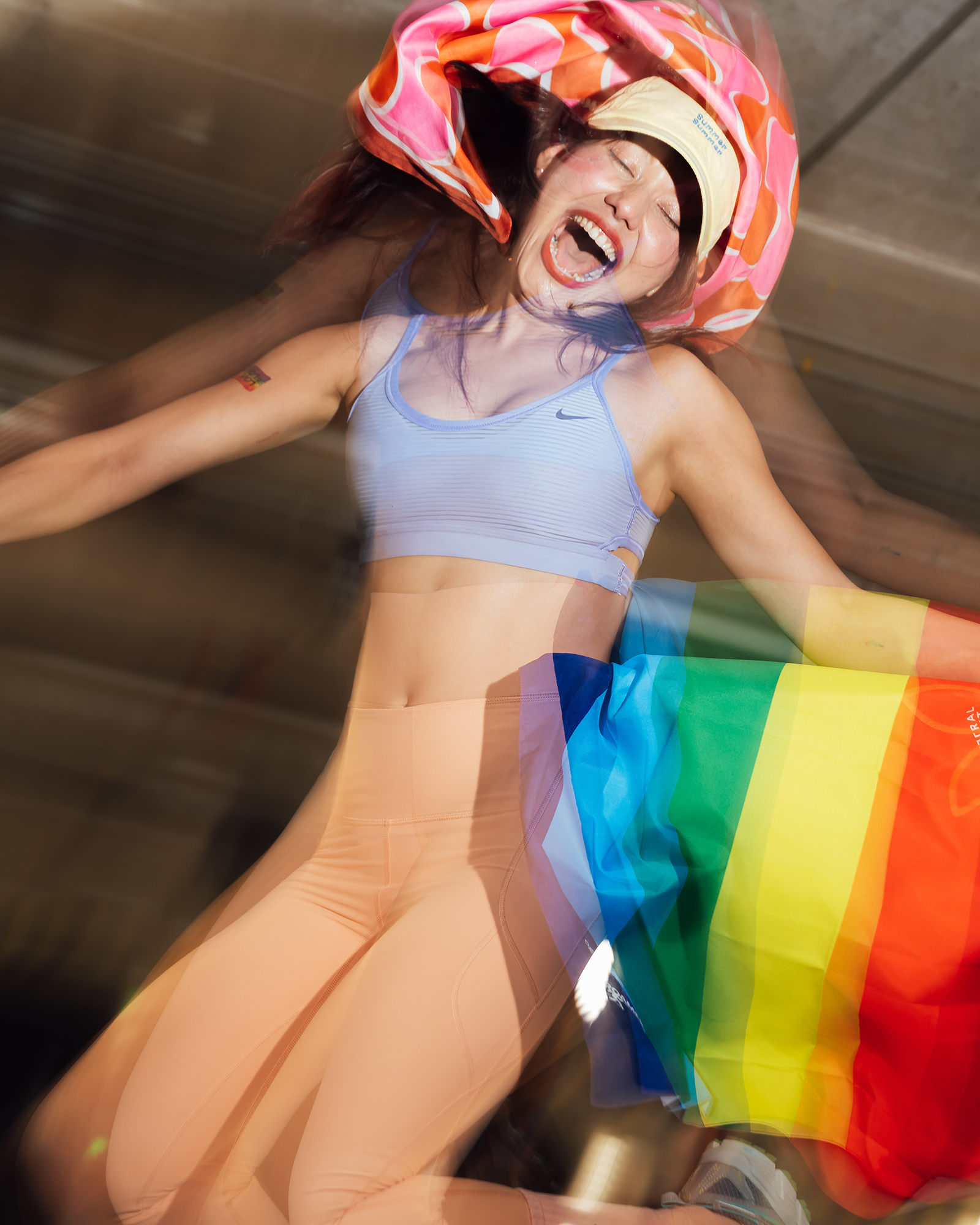 Central Phuket Beyond Move — runner laughing mid-motion while waving a rainbow flag