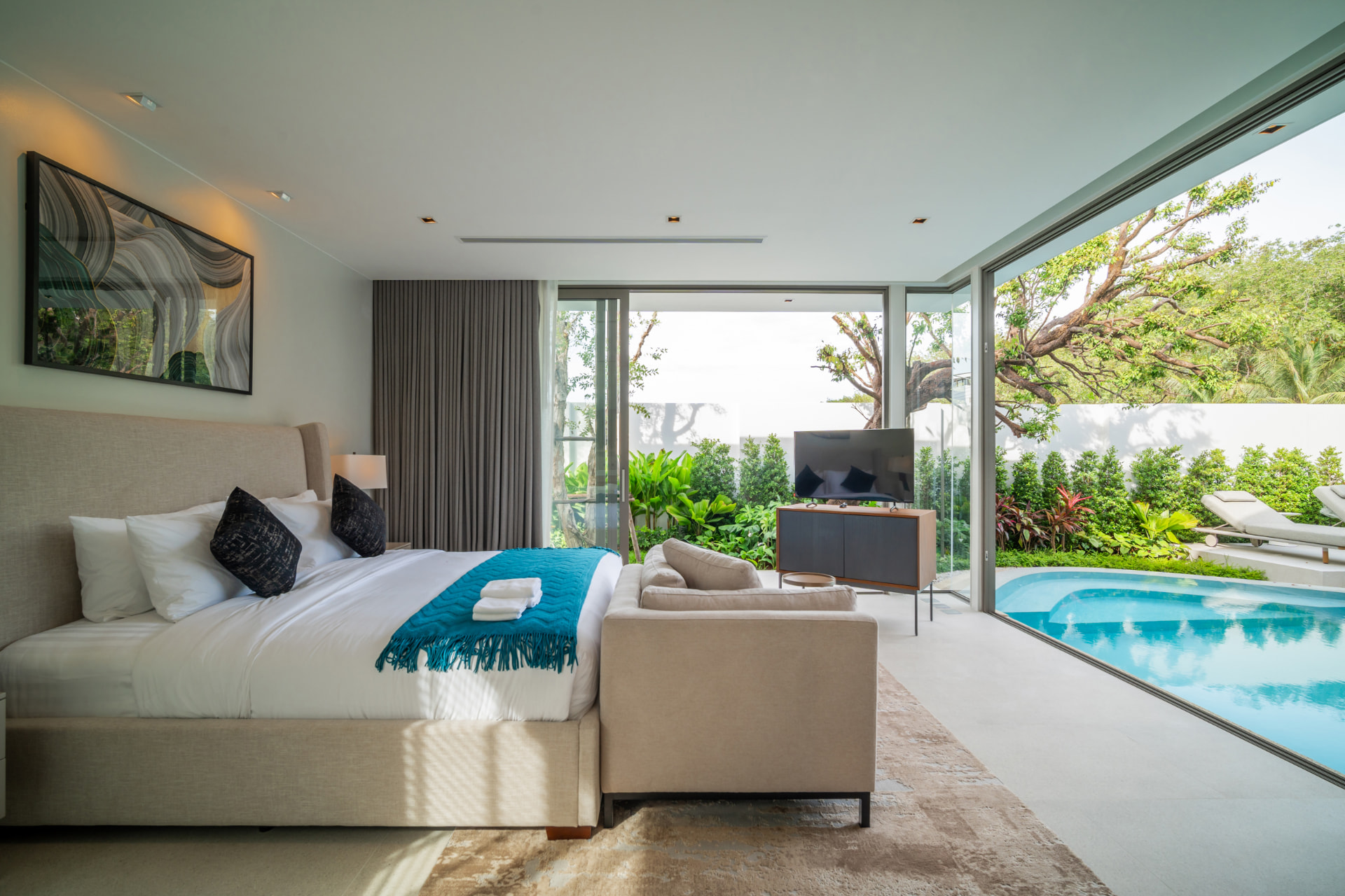 Botanica Louvre — master bedroom with wrap-around glass doors opening onto the pool and garden