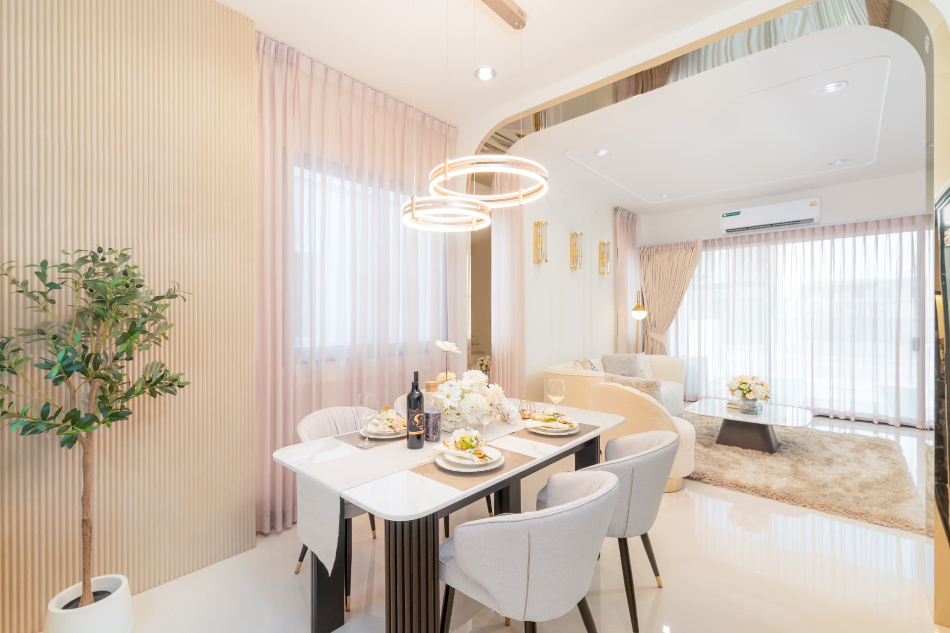 K Avenue II — dining nook set for a meal beneath ring chandeliers