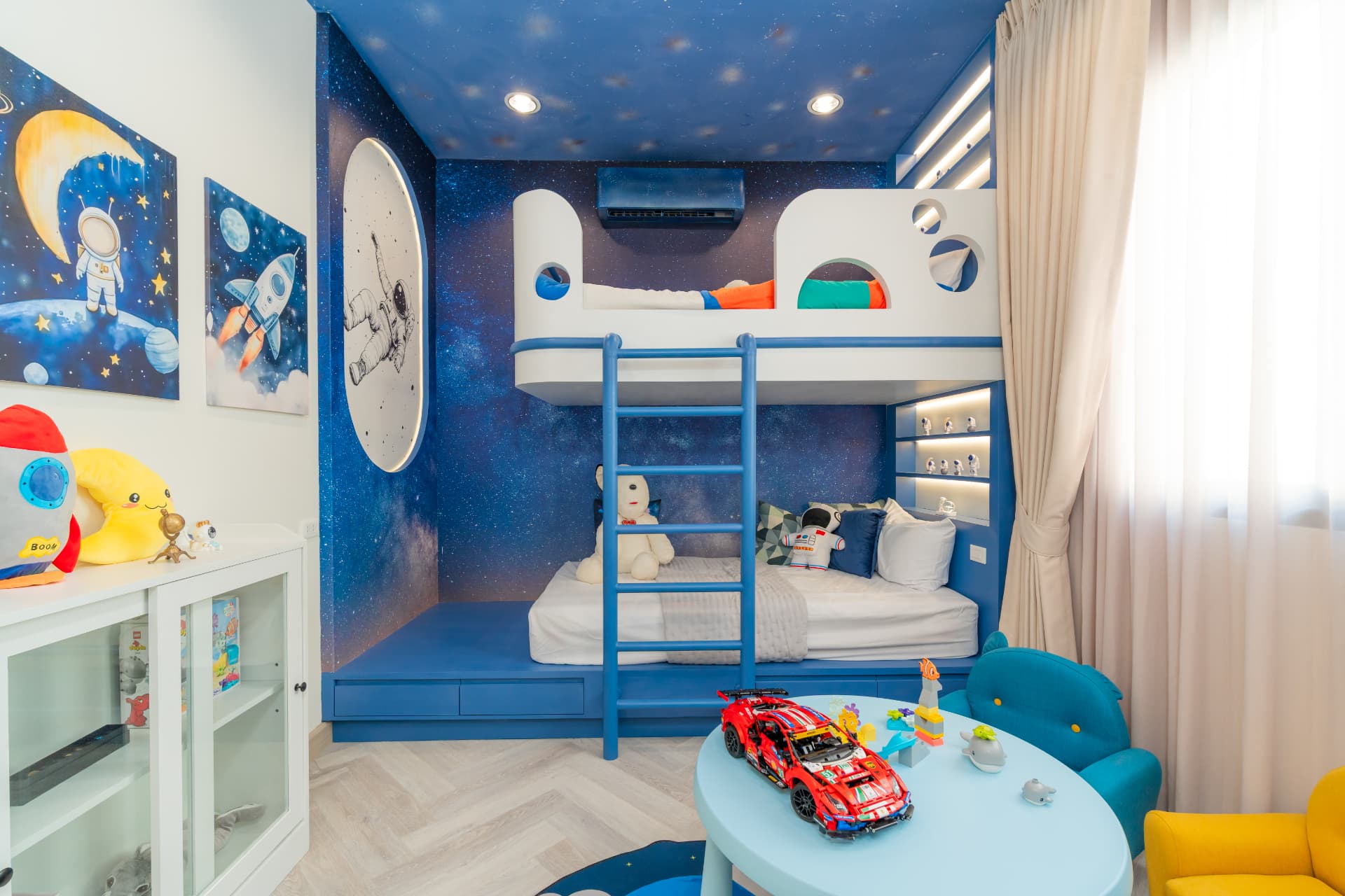 K Avenue II — children's bedroom with a space-themed bunk bed under a starry ceiling mural