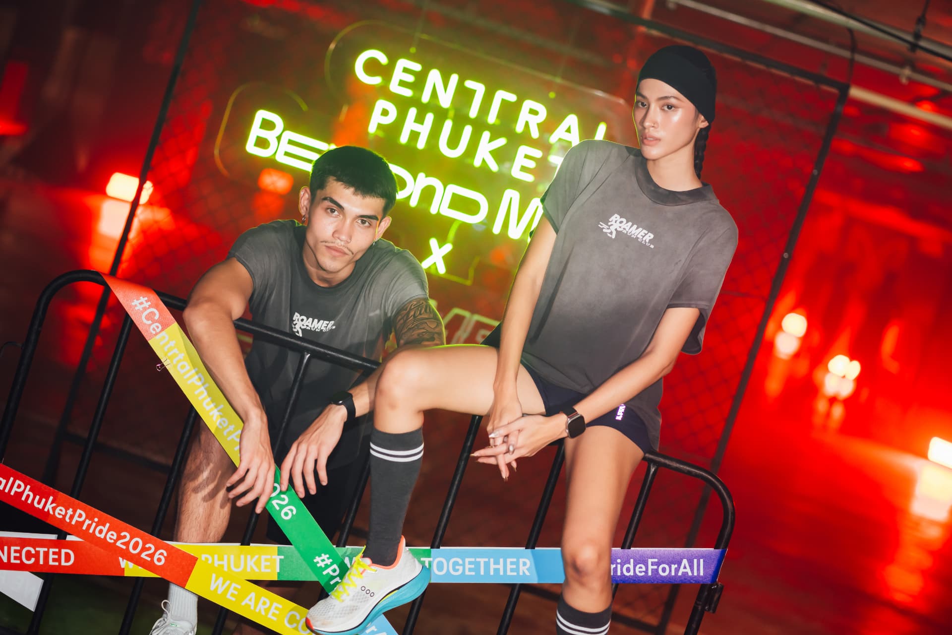 Central Phuket Beyond Move — two runners resting on a barrier under red light beside the Beyond Move x Roamer backdrop
