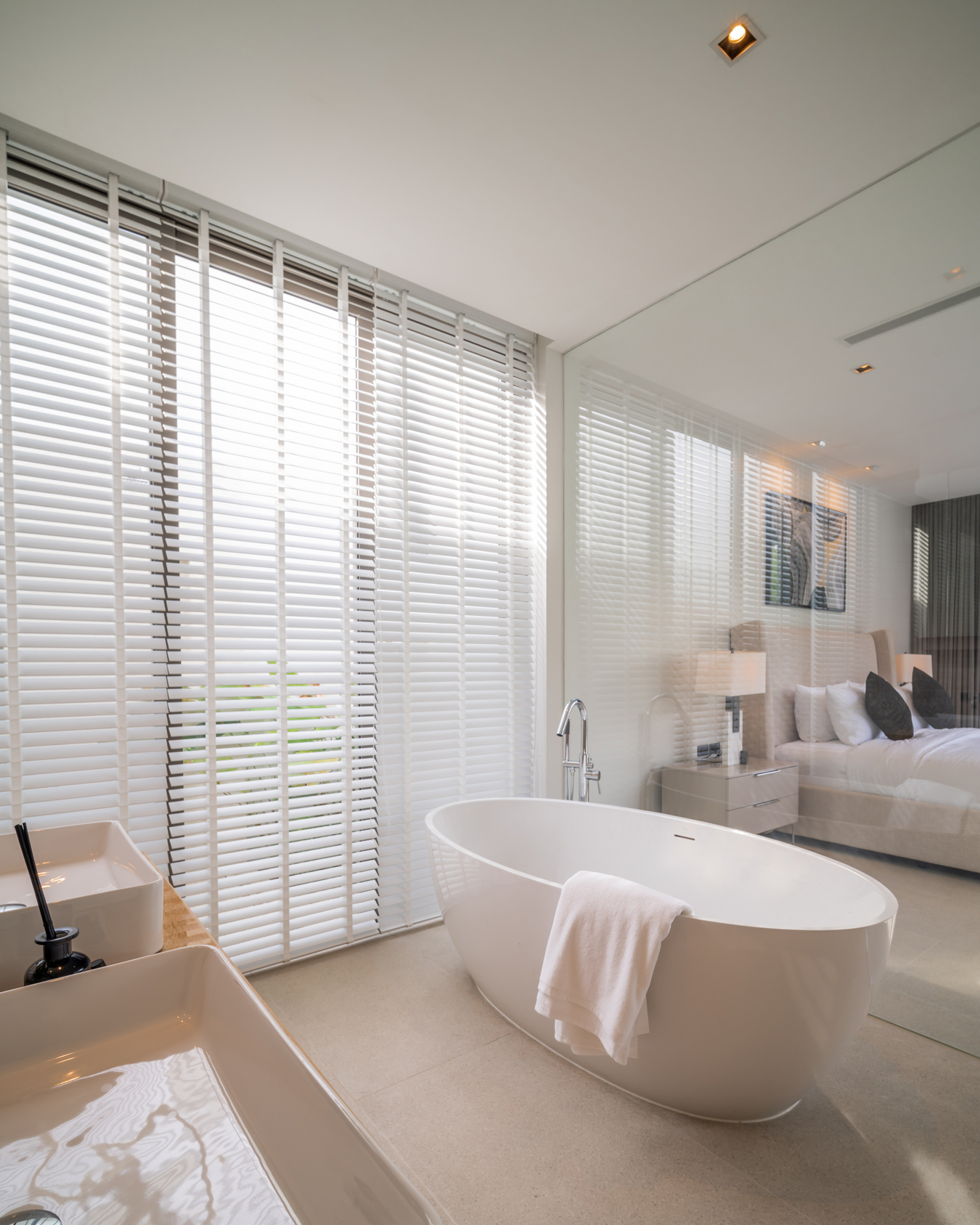 Botanica Louvre — freestanding bathtub by tall window blinds
