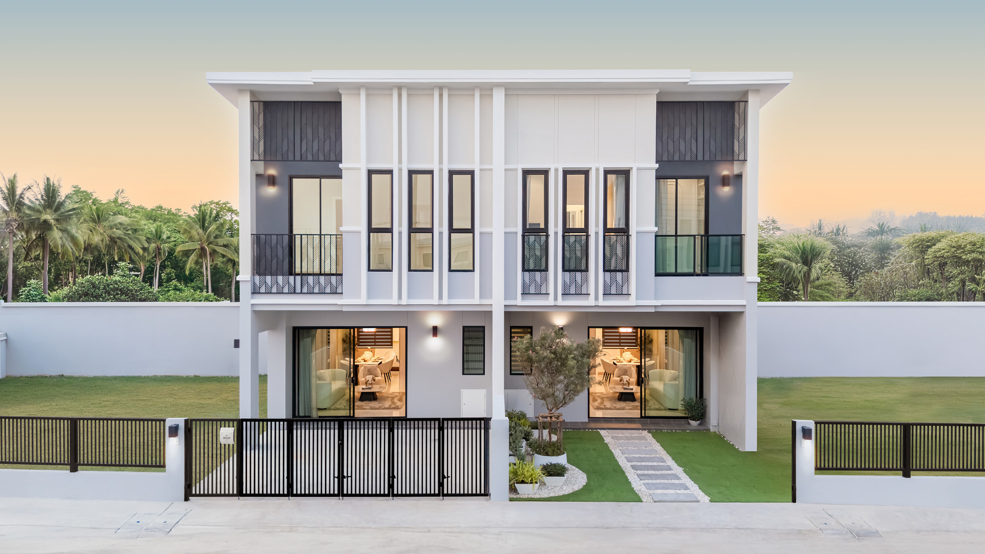 K AVENUE II — twin two-storey villas with lawns and driveways at dusk