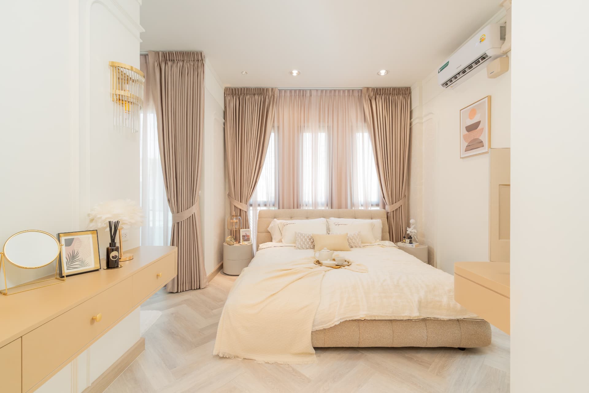 K Avenue II — pale bedroom with layered curtains and a dressed bedside console