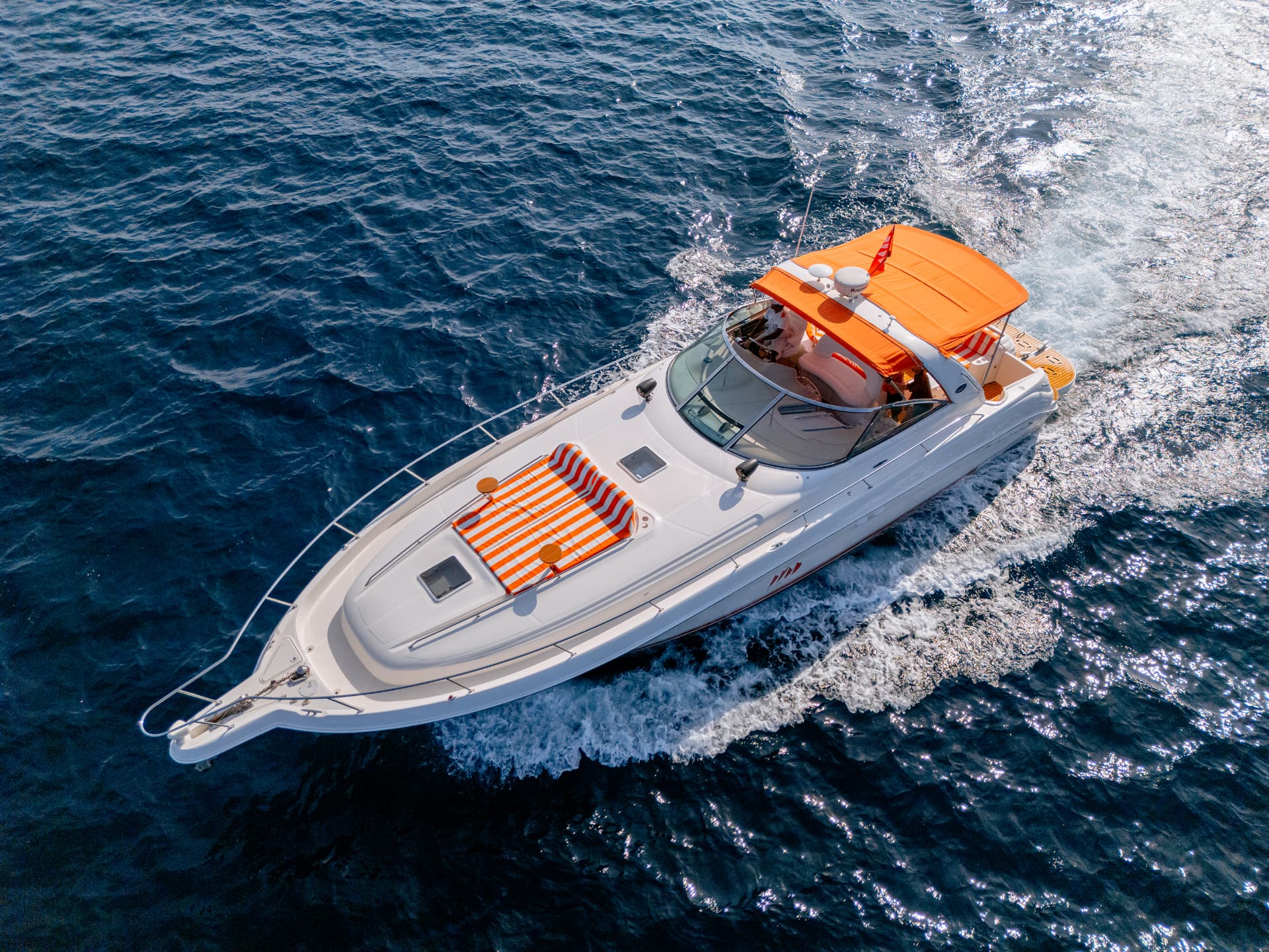 Once Yachting — aerial view of the yacht cruising through deep blue sea, leaving a white wake