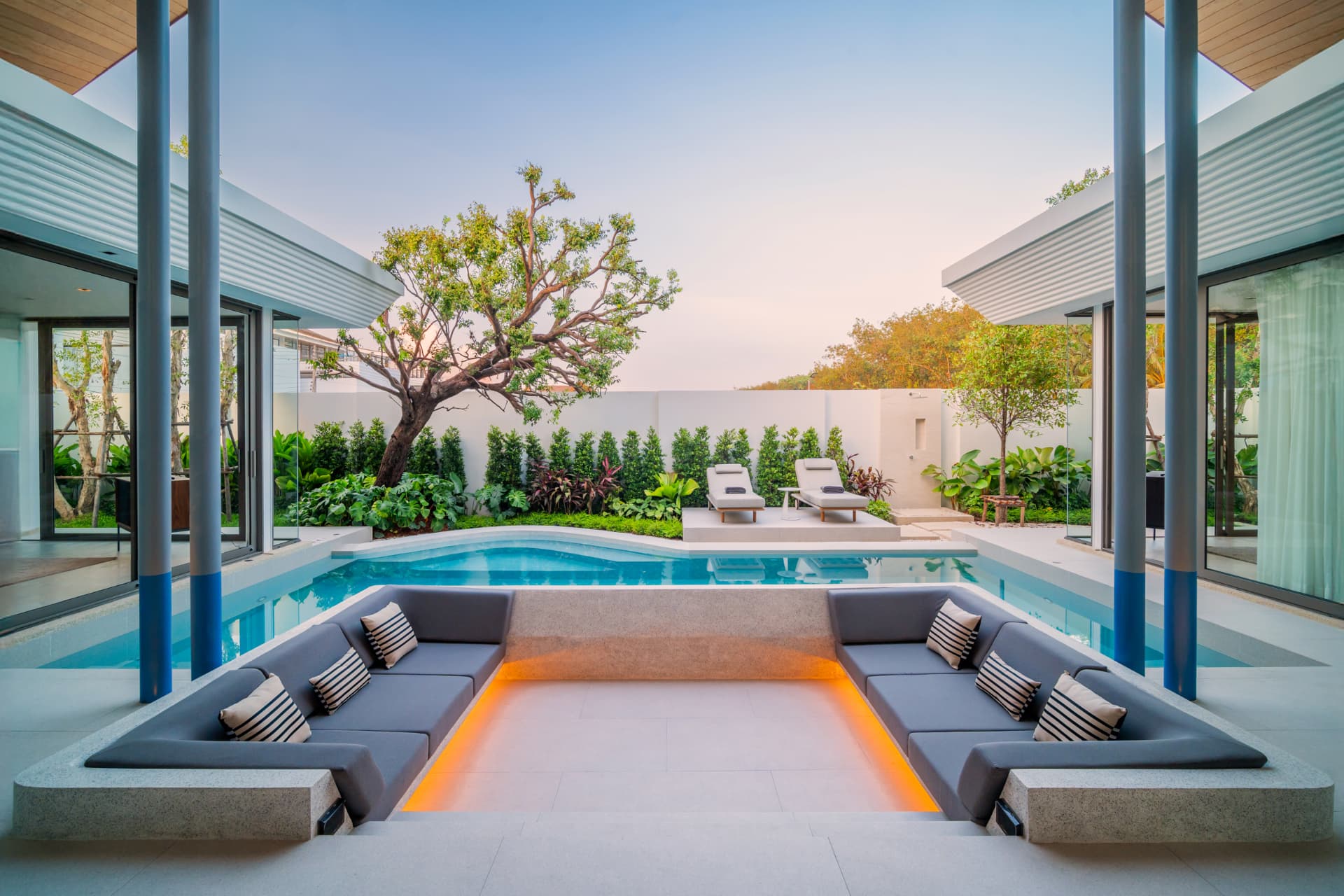 Botanica Louvre — sunken outdoor lounge with orange glow facing the pool