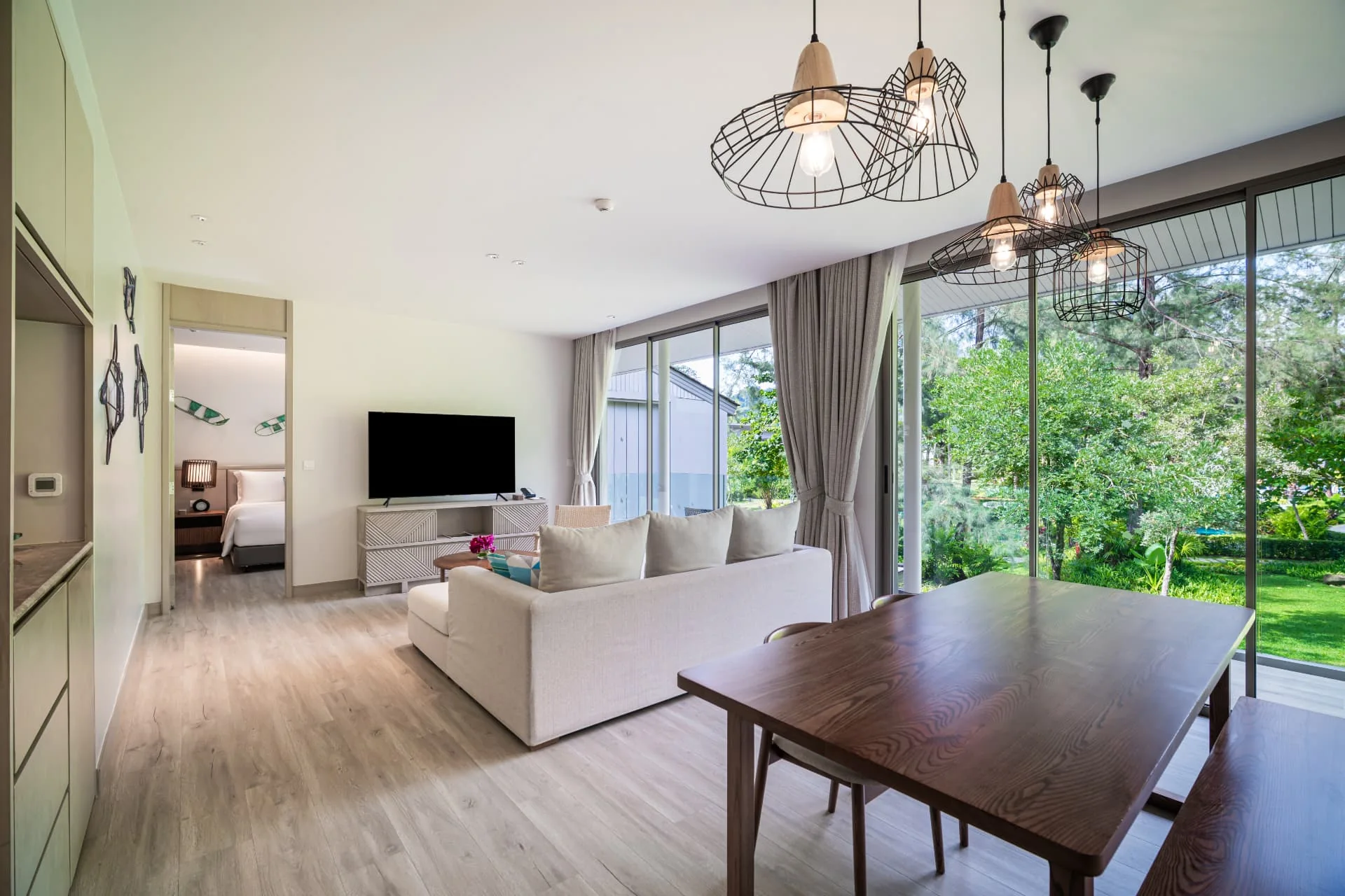 AVANI+ KAO LAK — Living and dining space opening to tropical greenery