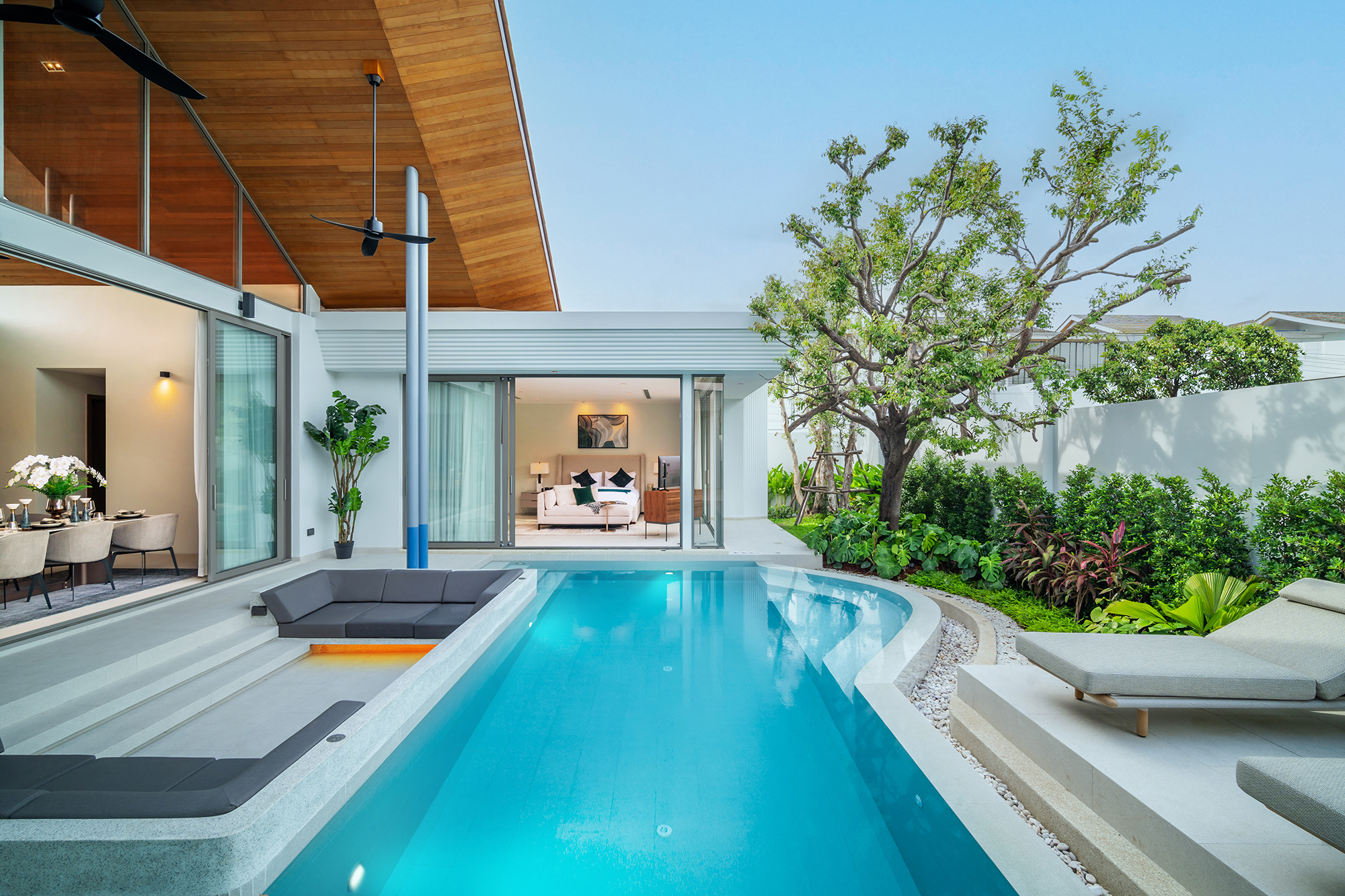 Botanica Louvre — pool courtyard with a sunken lounge, sun loungers and glass doors to the dining room