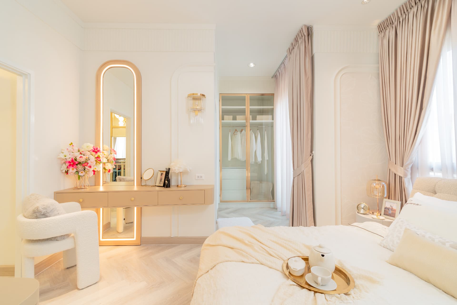K Avenue II — bedroom with an illuminated vanity mirror beside a neatly made bed