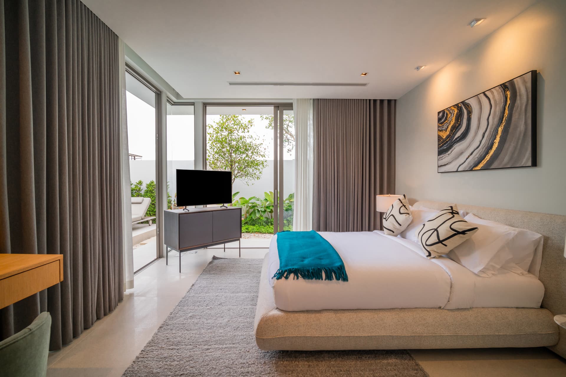 Botanica Louvre — bedroom with abstract artwork and teal throw