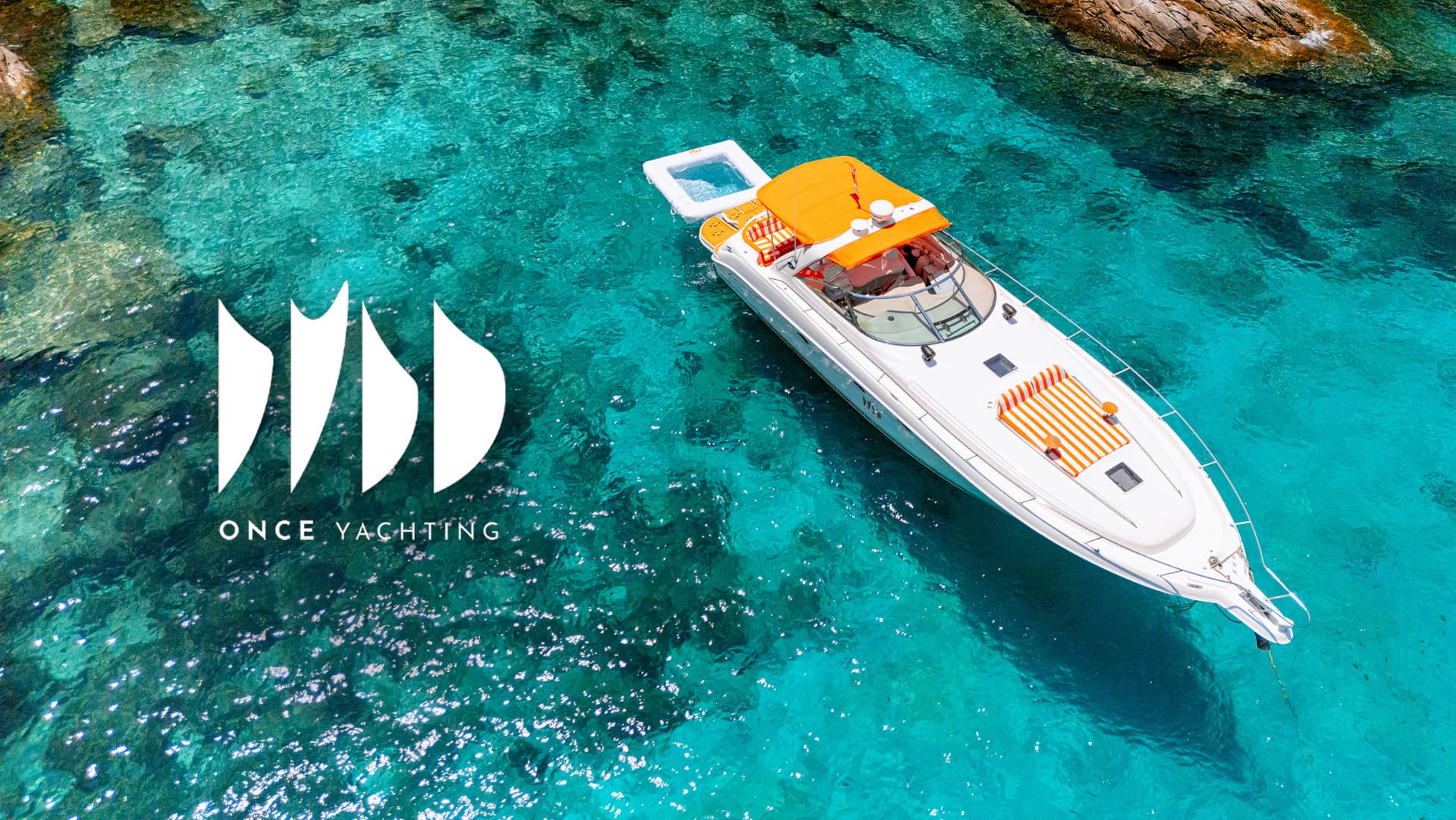 Once Yachting — aerial view of a white motor yacht with orange canopies and striped loungers in turquoise water, carrying the ONCE YACHTING logo
